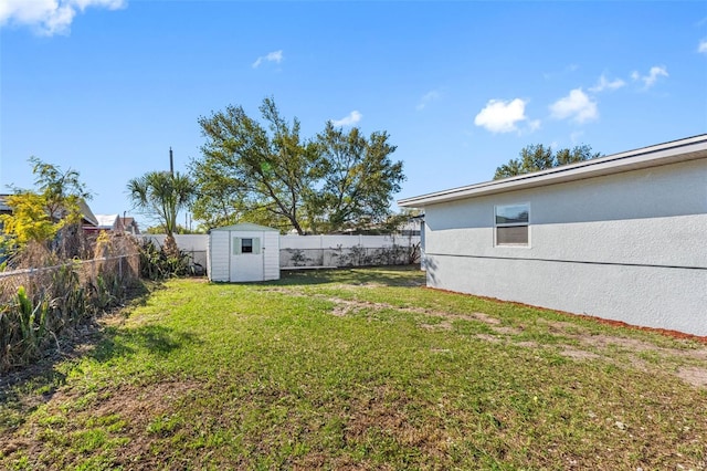 view of yard featuring a fenced backyard, an outdoor structure, and a storage unit