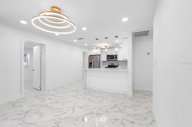 kitchen with marble finish floor, white cabinetry, stainless steel appliances, and recessed lighting