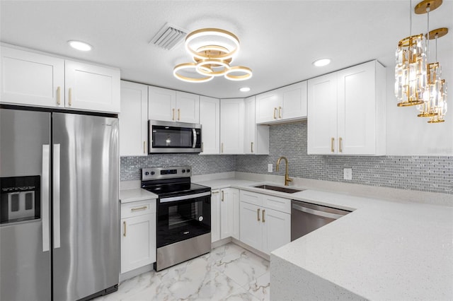 kitchen with marble finish floor, visible vents, appliances with stainless steel finishes, white cabinets, and a sink