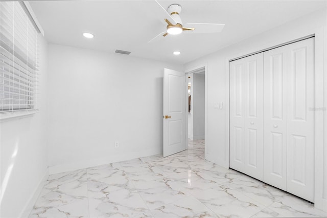 unfurnished bedroom with marble finish floor, recessed lighting, a closet, visible vents, and baseboards