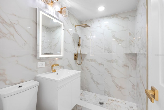 bathroom featuring toilet, a marble finish shower, tile walls, and vanity