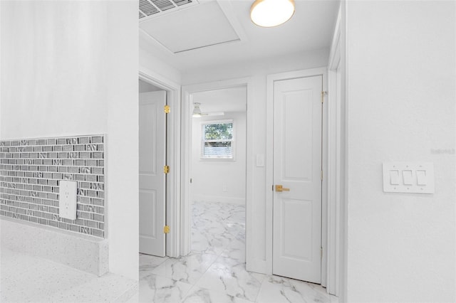 hall featuring attic access, marble finish floor, visible vents, and baseboards