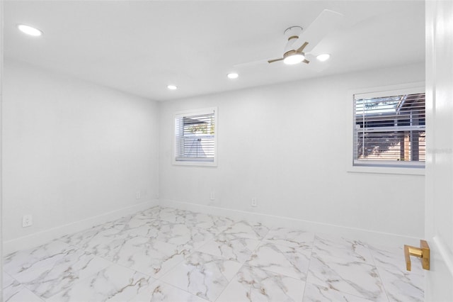 empty room featuring marble finish floor, baseboards, a ceiling fan, and recessed lighting