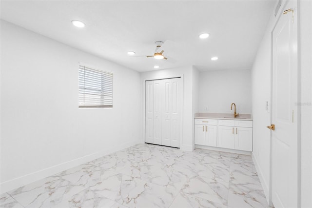 interior space featuring ceiling fan, recessed lighting, a sink, baseboards, and marble finish floor