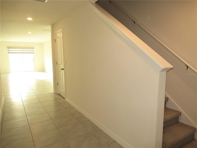 hall with light tile patterned floors, stairs, baseboards, and recessed lighting