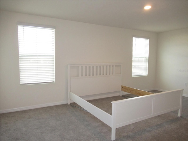 unfurnished bedroom with carpet, baseboards, and recessed lighting