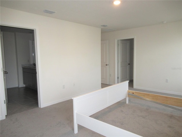 spare room featuring recessed lighting, carpet, visible vents, and baseboards