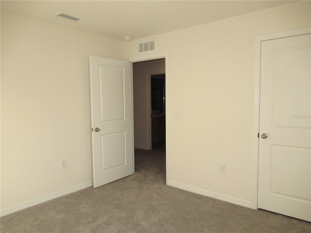 unfurnished bedroom with baseboards, visible vents, and carpet flooring