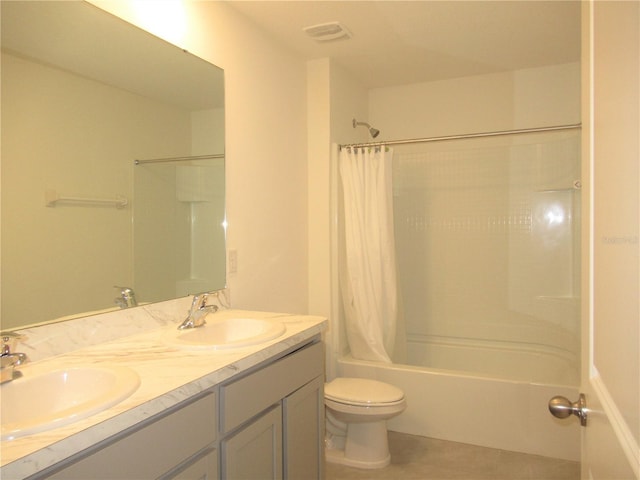 bathroom featuring toilet, shower / tub combo, visible vents, and a sink