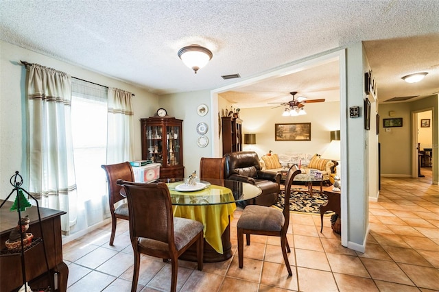 105 Country Club Ln, Mulberry, FL 33860 - dining area featuring light tile patterned floors, visible vents, baseboards, ceiling fan, and a textured ceiling