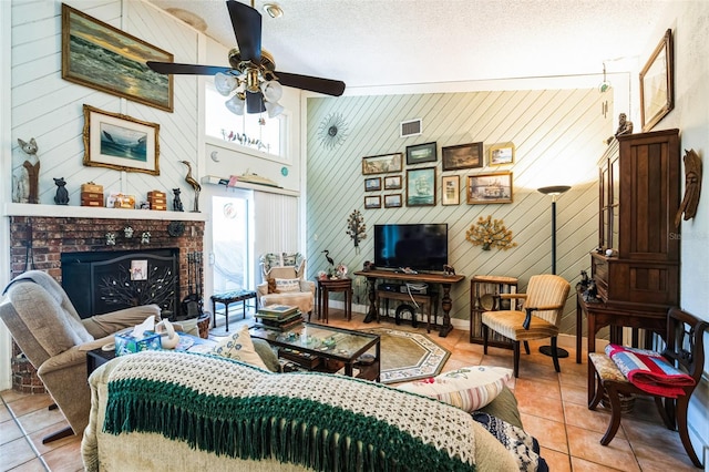 105 Country Club Ln, Mulberry, FL 33860 - tiled living area with visible vents, baseboards, ceiling fan, a fireplace, and a textured ceiling