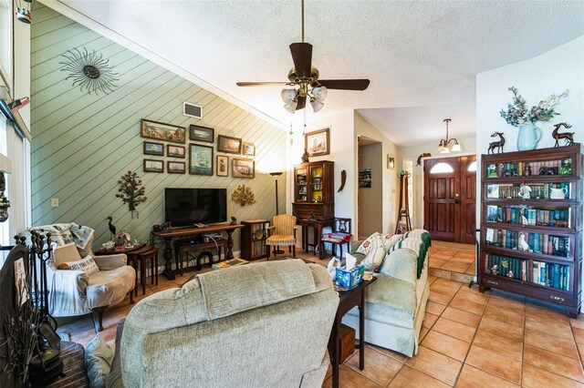 105 Country Club Ln, Mulberry, FL 33860 - living room with visible vents, a textured ceiling, light tile patterned flooring, and vaulted ceiling
