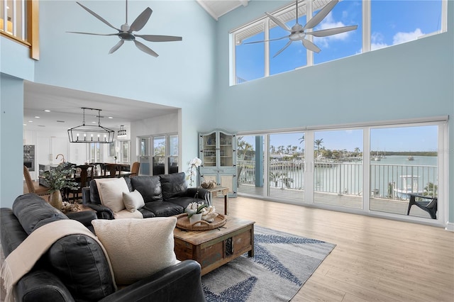 living room with wood finished floors and ceiling fan with notable chandelier