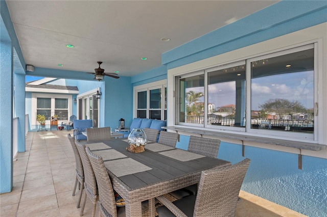 view of patio featuring a ceiling fan, outdoor dining space, and outdoor lounge area