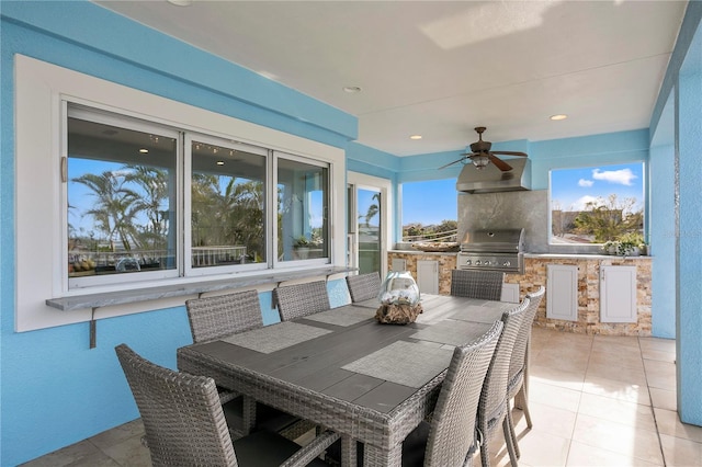 interior space featuring a ceiling fan, outdoor dining space, grilling area, and an outdoor kitchen