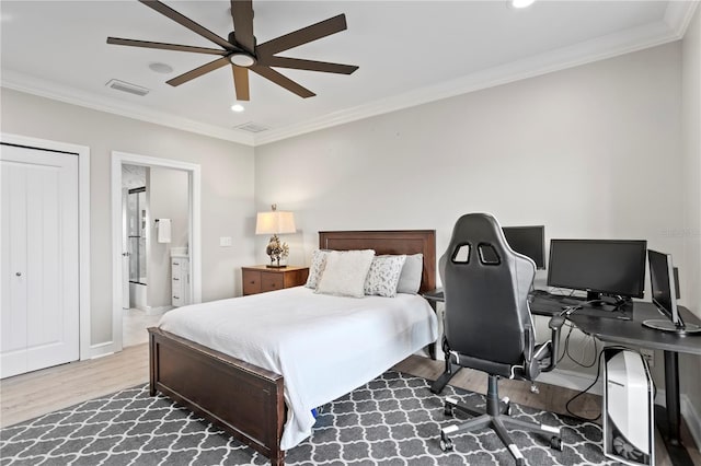 bedroom featuring ensuite bath, visible vents, ornamental molding, and wood finished floors