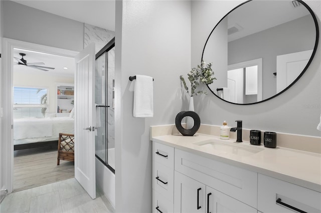 full bath featuring shower / bath combination with glass door, ceiling fan, ensuite bathroom, and vanity