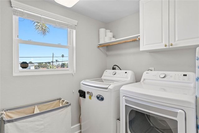 clothes washing area with cabinet space and washer and dryer