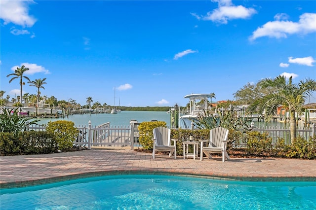 view of pool with a dock, a water view, boat lift, and a fenced in pool