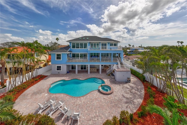 view of pool with a pool with connected hot tub, a fenced backyard, a patio, and stairway