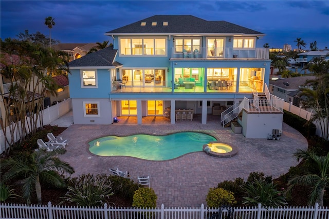 back of property with a patio, stucco siding, stairway, a balcony, and a fenced backyard