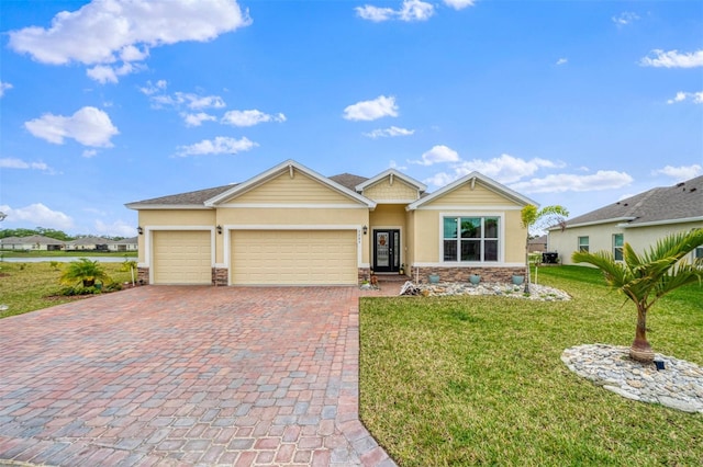 ranch-style home featuring decorative driveway, stucco siding, an attached garage, stone siding, and a front lawn