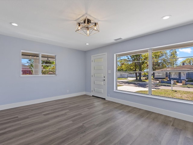 spare room with plenty of natural light, visible vents, and baseboards