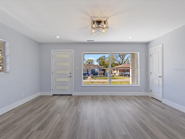 interior space with recessed lighting, wood finished floors, and baseboards