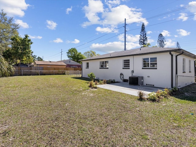 back of property with fence private yard, central AC, a yard, and a patio