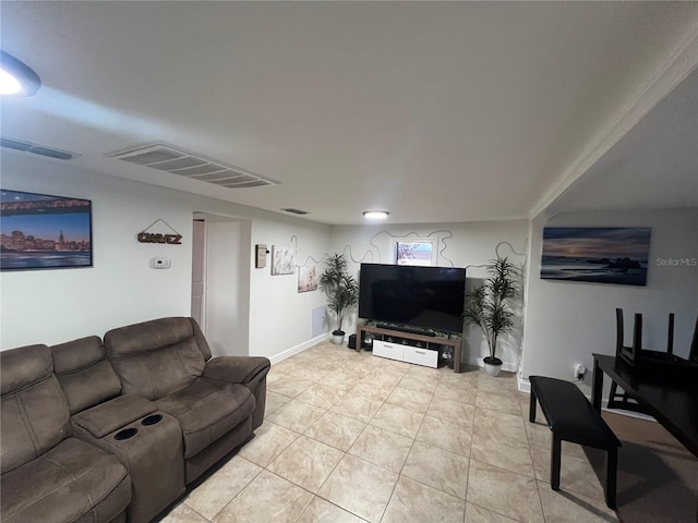 living room featuring light tile patterned floors, visible vents, and baseboards