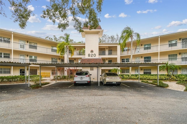 view of building exterior featuring covered parking