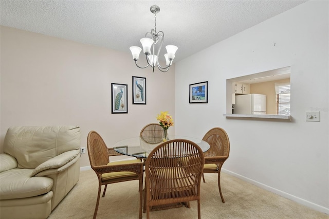 dining area featuring carpet floors, baseboards, a chandelier, and a textured ceiling