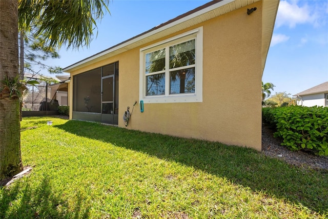 11714 Wrought Pine Loop, Riverview, FL 33569 - rear view of property with stucco siding, a lawn, and a sunroom