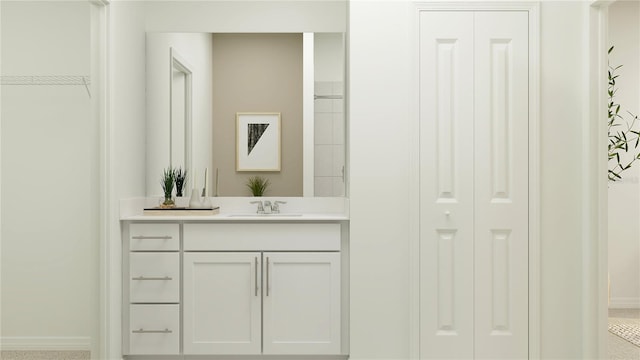 full bathroom featuring a closet, vanity, and baseboards