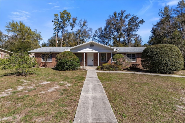 ranch-style house with a front lawn and brick siding