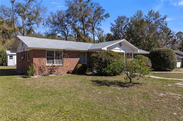 single story home featuring a front yard and brick siding