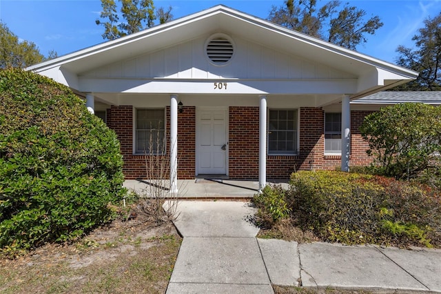 view of front facade featuring a porch and brick siding