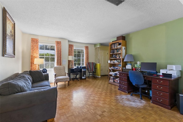 home office with visible vents and a textured ceiling