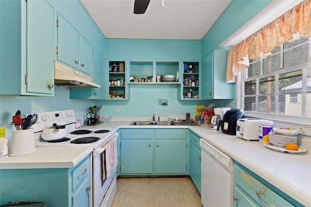 kitchen with light tile patterned floors, a sink, a textured ceiling, white appliances, and under cabinet range hood