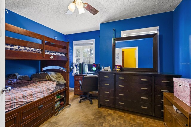 bedroom with ceiling fan and a textured ceiling