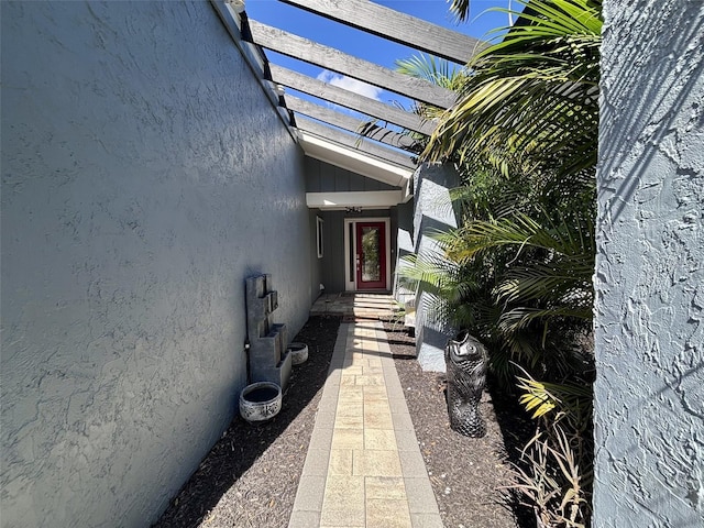 entrance to property featuring stucco siding