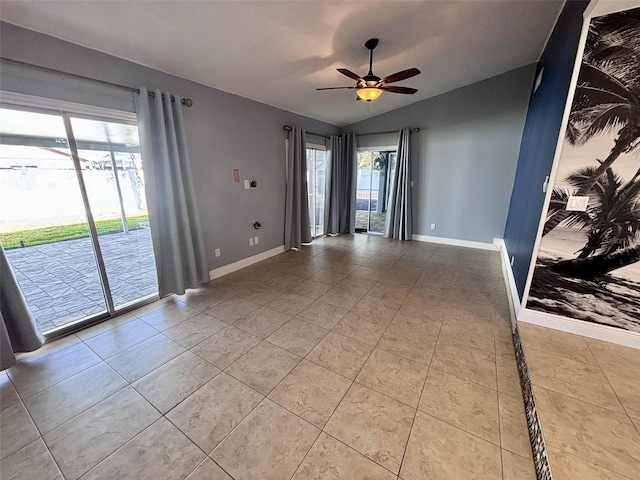 tiled empty room featuring lofted ceiling, baseboards, and ceiling fan