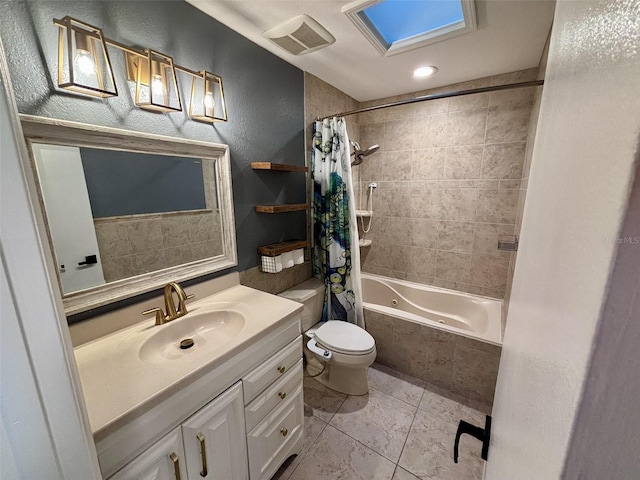 full bath featuring vanity, visible vents, shower / tub combo, toilet, and a textured wall