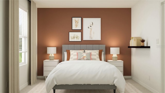 bedroom featuring light colored carpet and baseboards