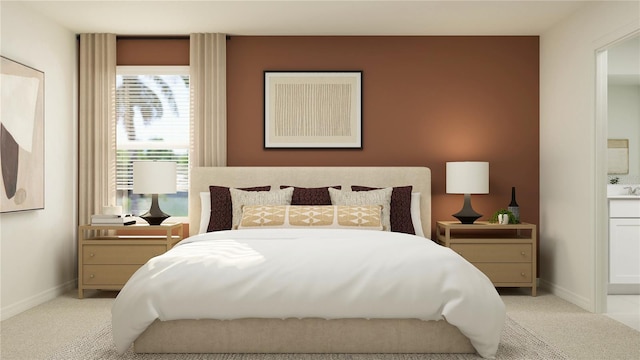 bedroom with baseboards, connected bathroom, and light colored carpet