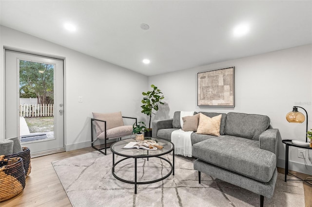 living area featuring recessed lighting, baseboards, and wood finished floors