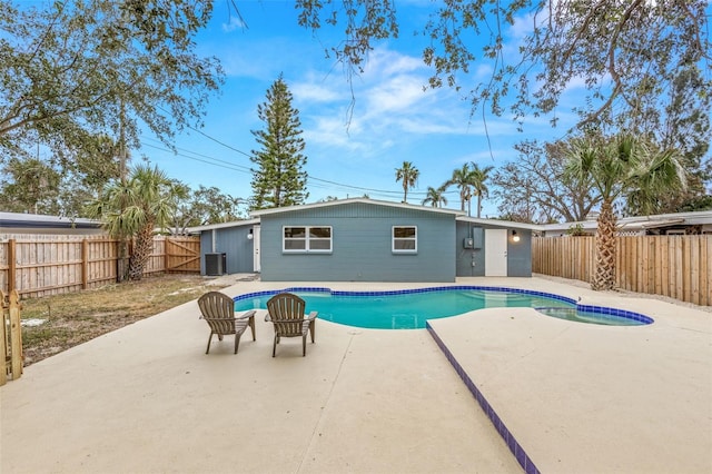 view of pool with a fenced in pool, a fenced backyard, a patio, and central AC unit