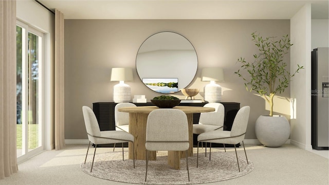 dining area featuring carpet flooring and baseboards