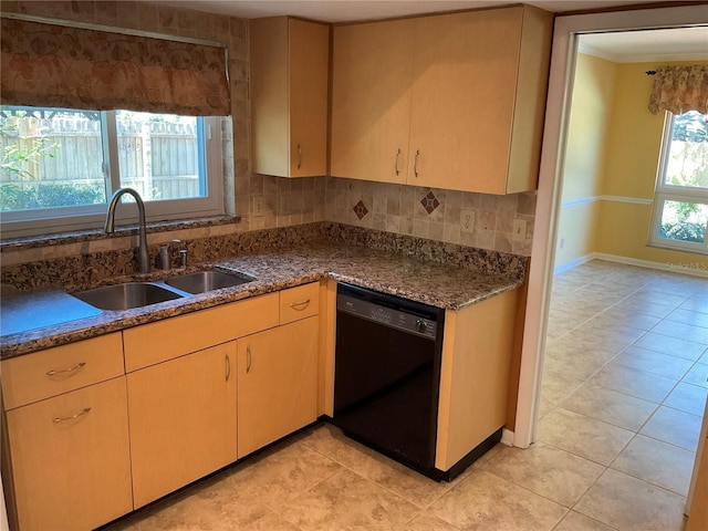 kitchen featuring light tile patterned floors, black dishwasher, baseboards, decorative backsplash, and a sink