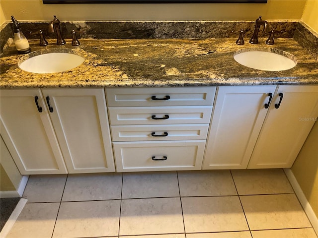 bathroom featuring double vanity, tile patterned flooring, and a sink